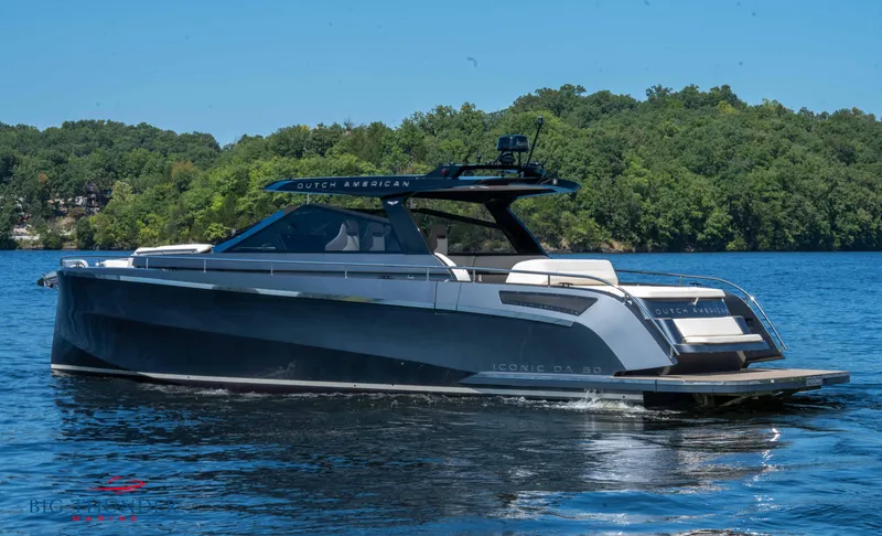 Slide: The Image of 2024 Dutch American Iconic DA 50 yacht on a serene lake with lush green backdrop. - 6