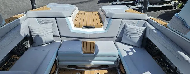 Slide: The Image of 2025 Nautique Super Air Nautique G23 interior with luxurious seating and teak accents. - 10