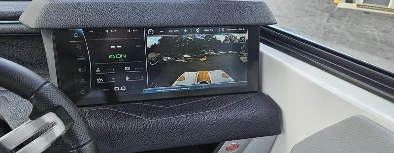 Slide: The Image of 2025 Nautique Super Air Nautique G23 dashboard with touchscreen display and rearview camera. - 14