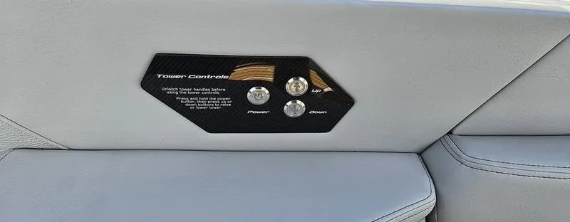 Slide: The Image of 2025 Nautique Super Air Nautique G23 tower control panel on gray upholstery. - 15