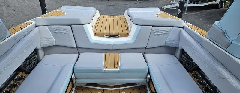 Slide: The Image of 2025 Nautique Super Air Nautique G23 interior with luxurious seating and teak accents. - 20