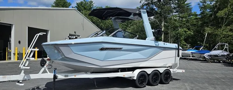 Slide: The Image of 2025 Nautique Super Air Nautique G23 boat on trailer, parked outdoors. - 25