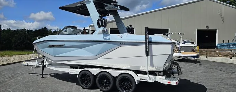 Slide: The Image of 2025 Nautique Super Air Nautique G23 boat on trailer, parked outdoors. - 33