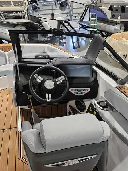 Slide: The Image of 2025 Nautique Super Air Nautique GS20 boat interior with modern dashboard and steering wheel. - 2