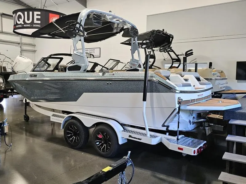 Slide: The Image of 2025 Nautique Super Air Nautique GS20 boat on trailer in showroom. - 3