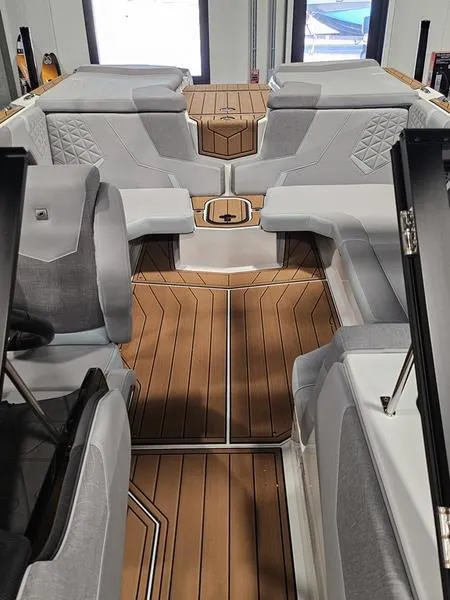Slide: The Image of 2025 Nautique Super Air Nautique GS20 interior with sleek seating and wood flooring. - 5