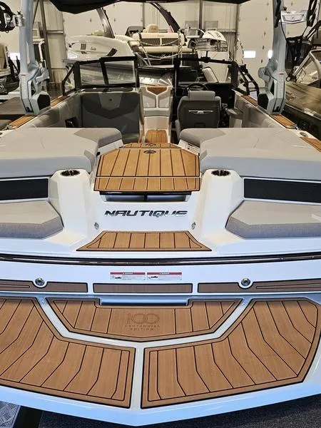Slide: The Image of 2025 Nautique Super Air Nautique GS20 boat with sleek design and wood accents. - 6