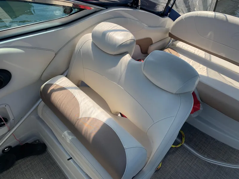 Slide: The Image of 2018 Crownline 264 CR boat interior with beige seating and carpeted flooring. - 10