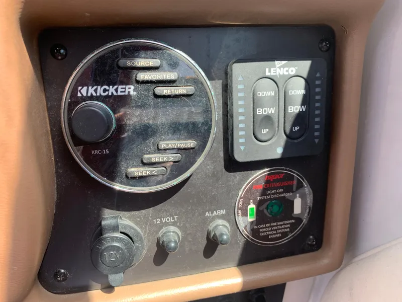 Slide: The Image of Control panel of 2018 Crownline 264 CR boat with Kicker audio and Lenco trim controls. - 19