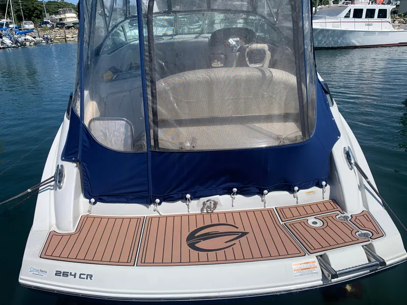 Slide: The Image of 2018 Crownline 264 CR boat docked, featuring a sleek design and spacious deck. - 2