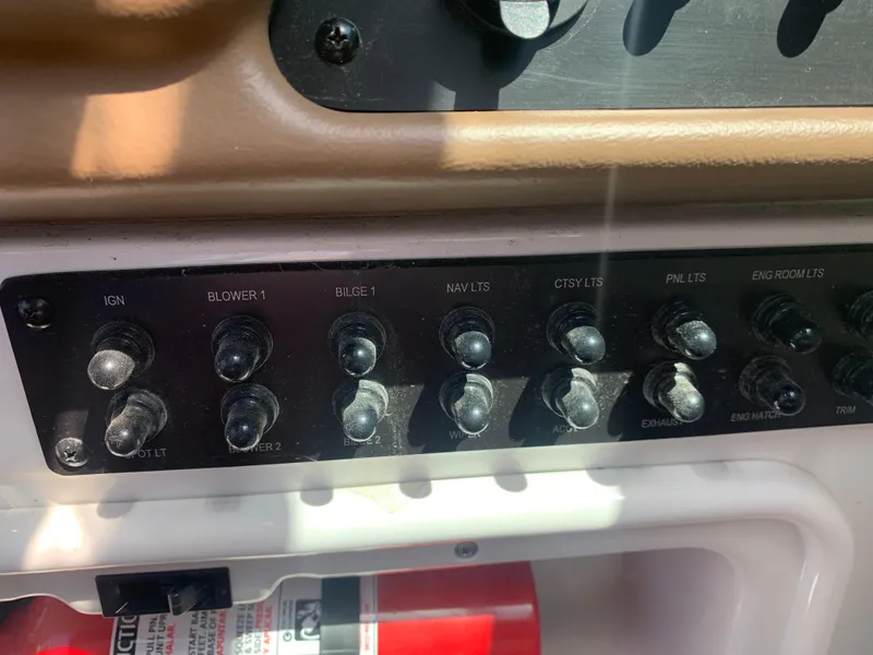 Slide: The Image of Control panel of a 2018 Crownline 264 CR boat with labeled switches. - 20