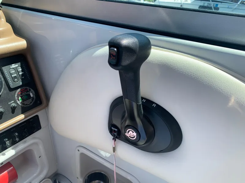 Slide: The Image of 2018 Crownline 264 CR boat throttle control in cockpit, featuring sleek design and intuitive controls. - 22