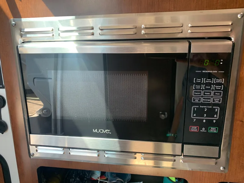 Slide: The Image of Built-in microwave in 2018 Crownline 264 CR boat kitchen area. - 25