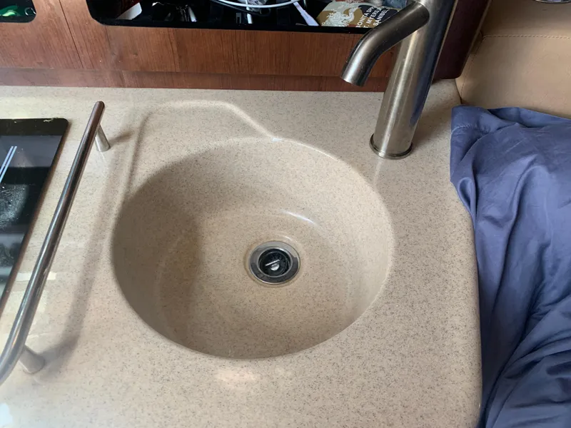Slide: The Image of 2018 Crownline 264 CR boat sink with modern faucet in cabin interior. - 28