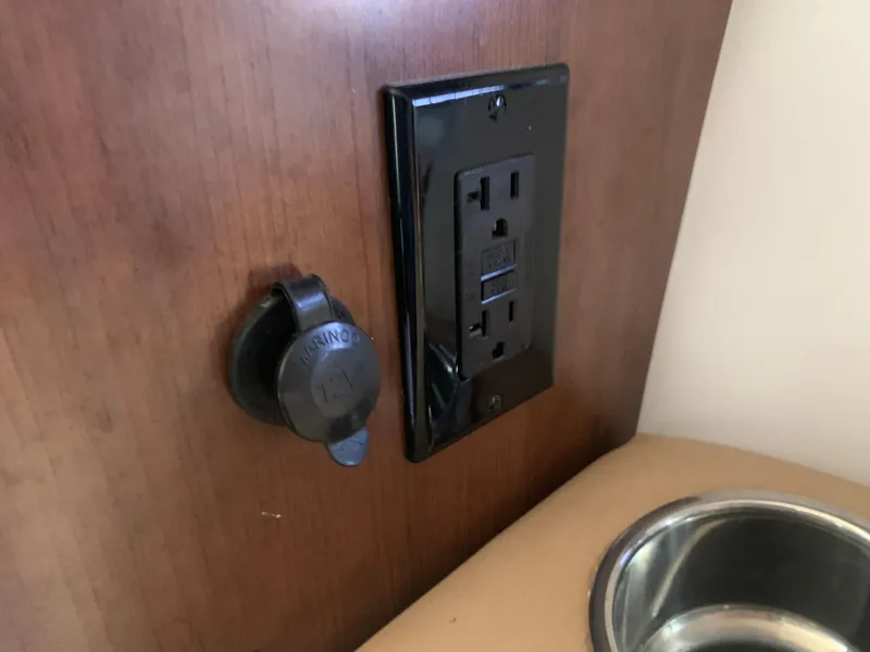 Slide: The Image of Power outlet and USB port on 2018 Crownline 264 CR boat interior. - 33