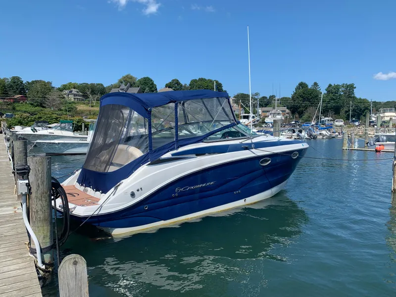Slide: The Image of 2018 Crownline 264 CR boat docked in a marina under a clear blue sky. - 4