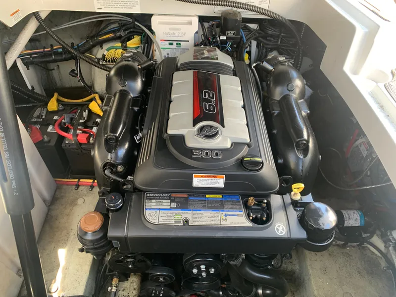 Slide: The Image of 2018 Crownline 264 CR engine compartment with 6.2L engine and battery setup. - 42