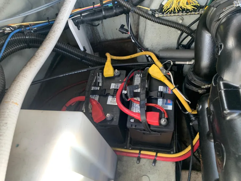 Slide: The Image of 2018 Crownline 264 CR boat engine compartment with dual batteries and wiring. - 43