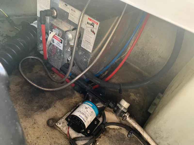 Slide: The Image of 2018 Crownline 264 CR engine compartment with wiring and pump system. - 44