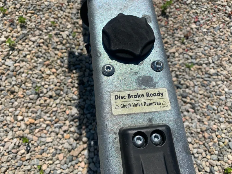 Slide: The Image of Close-up of a 2018 Crownline 264 CR disc brake system with a warning label. - 48