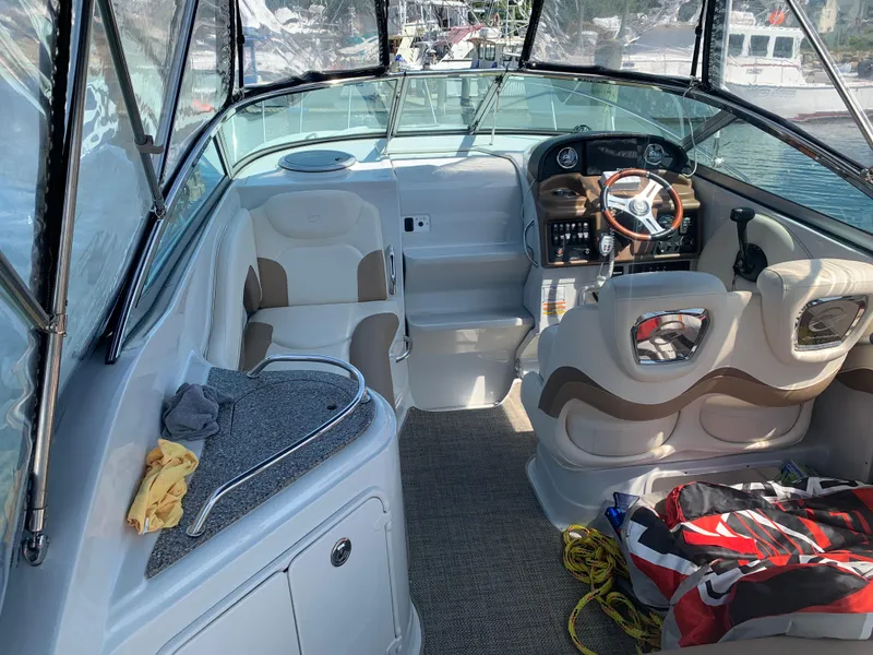 Slide: The Image of 2018 Crownline 264 CR boat interior with helm, seating, and dashboard. - 6