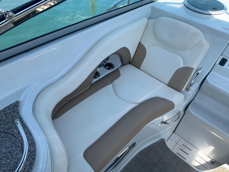 Slide: The Image of 2018 Crownline 264 CR boat interior seating with white and tan upholstery. - 9