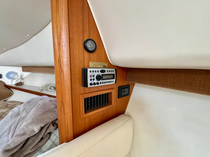 Slide: The Image of Interior of 2006 Tiara Yachts 29 Open, featuring control panel and wood finish. - 11
