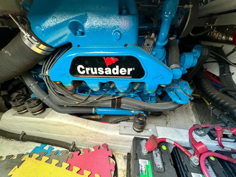 Slide: The Image of Crusader engine in 2006 Tiara Yachts 29 Open, showcasing vibrant blue components. - 14