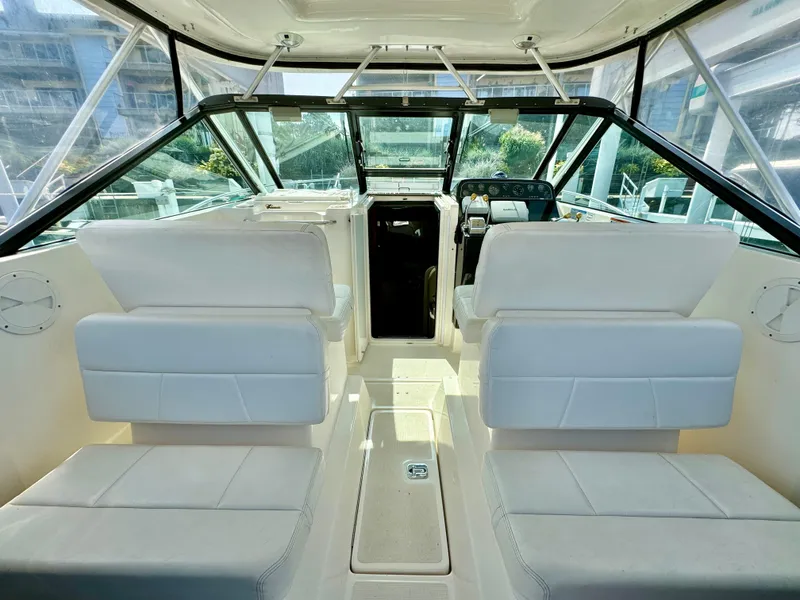 Slide: The Image of Interior of 2006 Tiara Yachts 29 Open, featuring white seating and helm. - 4