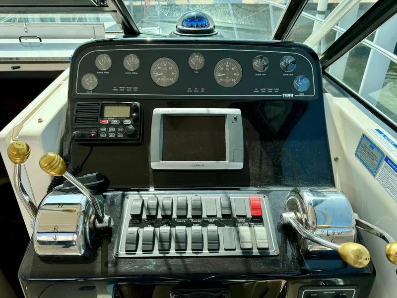 Slide: The Image of 2006 Tiara Yachts 29 Open dashboard with gauges, controls, and Garmin display. - 5