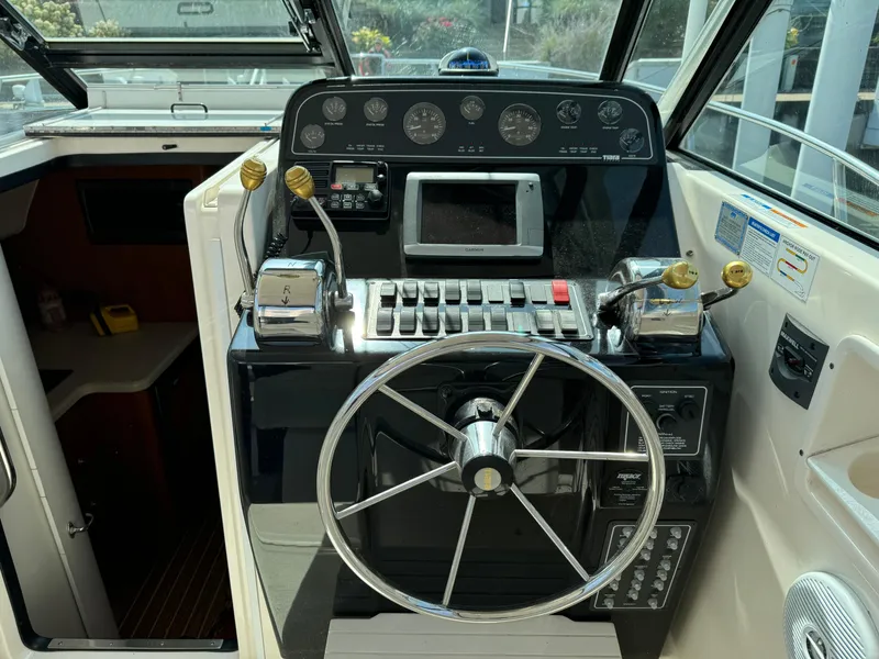 Slide: The Image of 2006 Tiara Yachts 29 Open helm with steering wheel and control panel. - 6