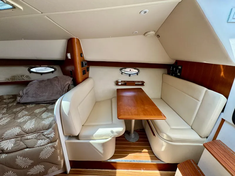 Slide: The Image of 2006 Tiara Yachts 29 Open cabin interior with dining area and bed. - 9