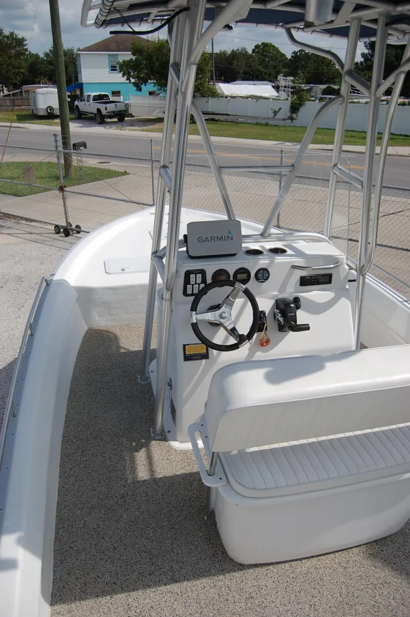 Slide: The Image of 2004 Cape Horn Cape Bay boat interior with steering console and Garmin equipment. - 13
