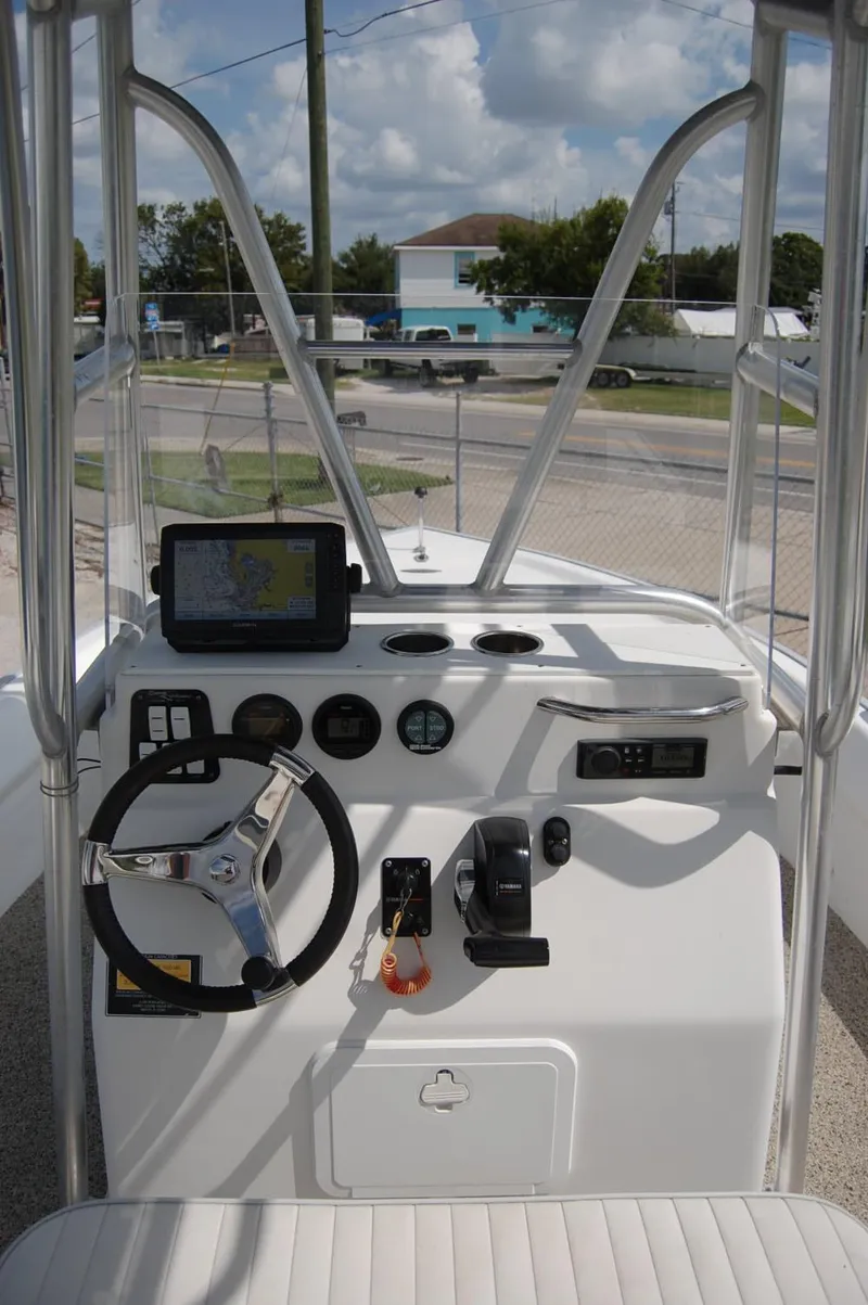 Slide: The Image of 2004 Cape Horn Cape Bay boat console with steering wheel and navigation equipment. - 19