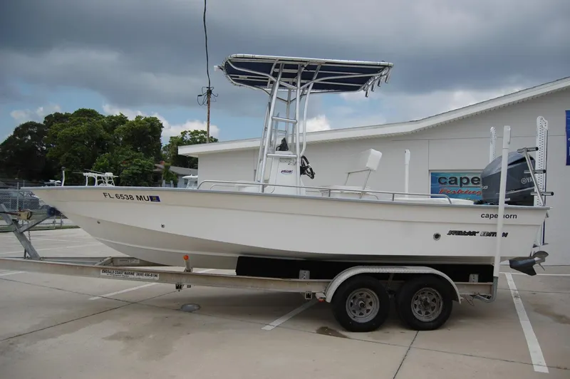 Slide: The Image of 2004 Cape Horn Cape Bay boat on trailer, parked outdoors under cloudy sky. - 4