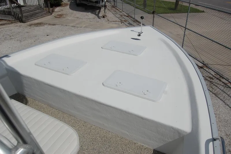 Slide: The Image of 2004 Cape Horn Cape Bay boat deck with storage hatches, parked on gravel. - 9