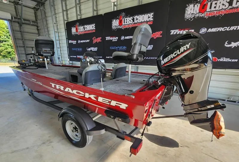 Slide: The Image of 2021 Tracker Pro 170 boat with Mercury engine in showroom setting. - 4
