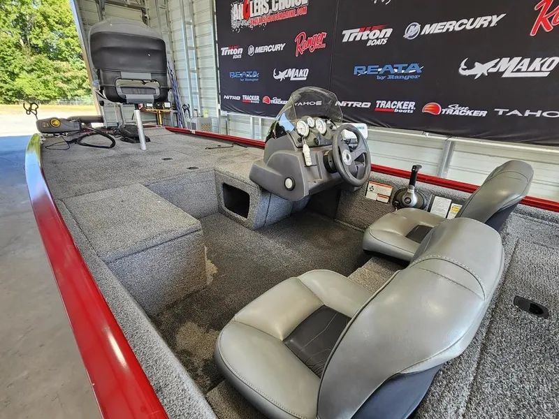 Slide: The Image of 2021 Tracker Pro 170 boat interior with gray seating and steering console. - 8