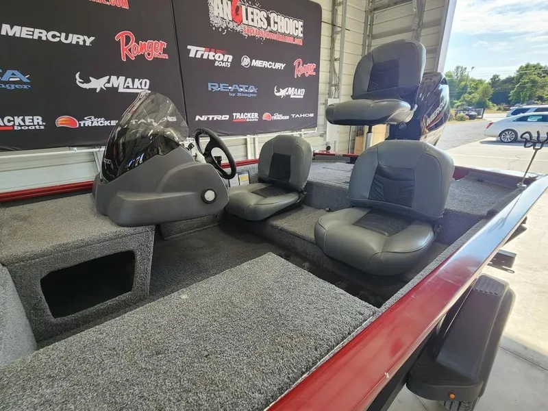 Slide: The Image of 2021 Tracker Pro 170 boat interior with gray seating and steering console. - 9
