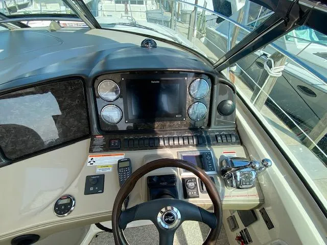 Slide: The Image of 2008 Sea Ray 440 Sundancer helm with navigation controls and steering wheel. - 10