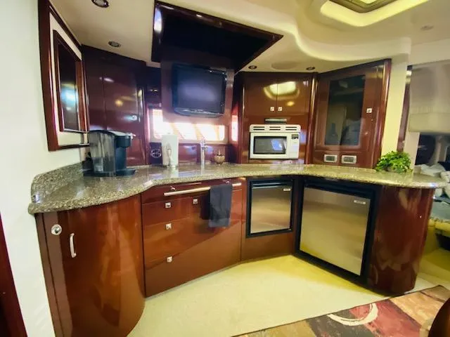 Slide: The Image of Luxurious kitchen interior of 2008 Sea Ray 440 Sundancer yacht with modern appliances. - 18