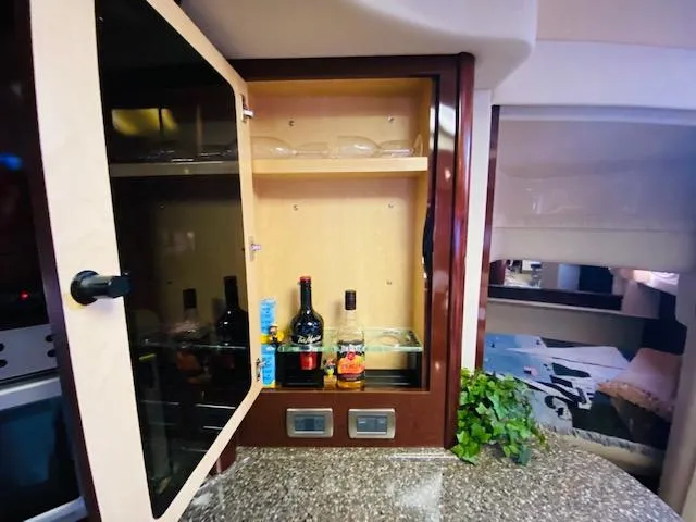 Slide: The Image of Luxury yacht interior with open cabinet, Sea Ray 440 Sundancer 2008. - 19