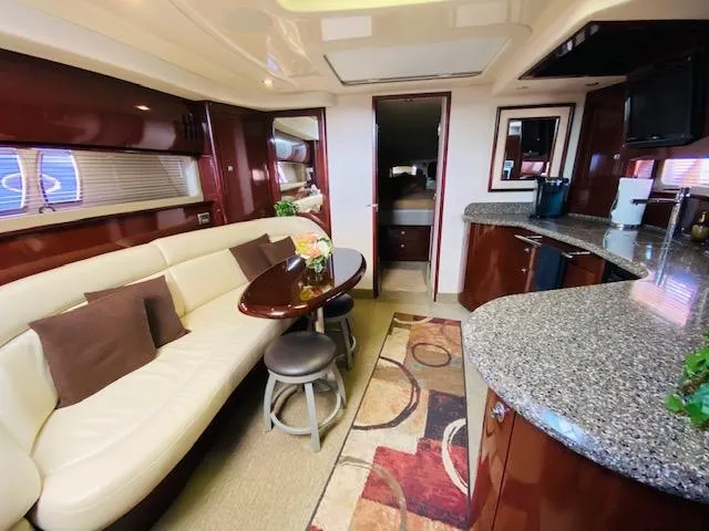 Slide: The Image of Luxurious interior of 2008 Sea Ray 440 Sundancer yacht with elegant seating and modern kitchen. - 24