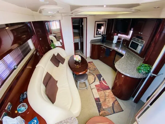 Slide: The Image of Luxurious interior of 2008 Sea Ray 440 Sundancer yacht with modern kitchen and seating area. - 25