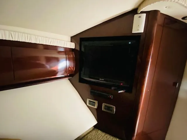 Slide: The Image of Interior of 2008 Sea Ray 440 Sundancer with TV and wood cabinetry. - 30
