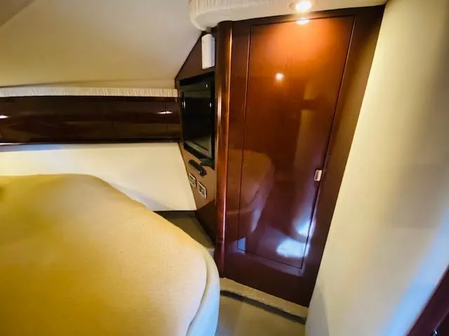 Slide: The Image of Luxurious cabin interior of 2008 Sea Ray 440 Sundancer yacht with wood paneling. - 31