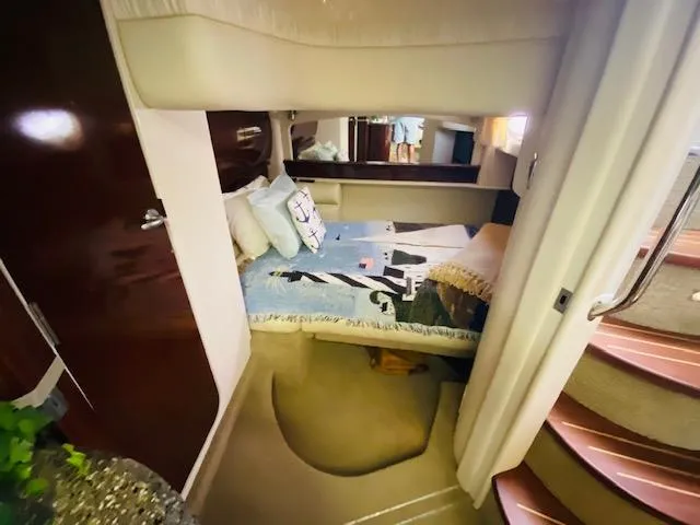 Slide: The Image of Interior cabin of 2008 Sea Ray 440 Sundancer yacht, featuring cozy bed and elegant decor. - 33