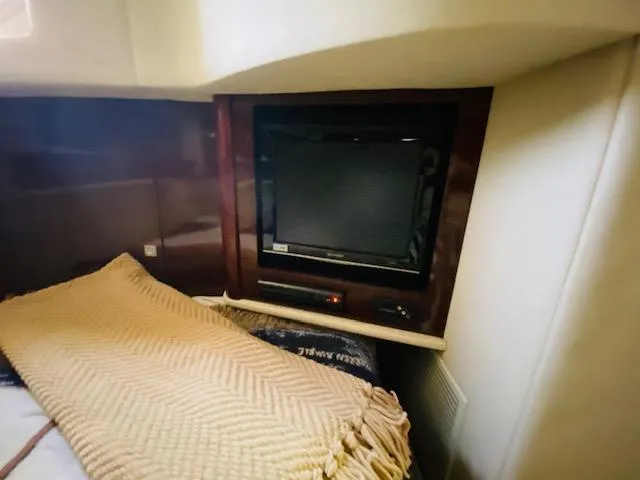Slide: The Image of Interior of 2008 Sea Ray 440 Sundancer with TV and cozy bedding. - 35
