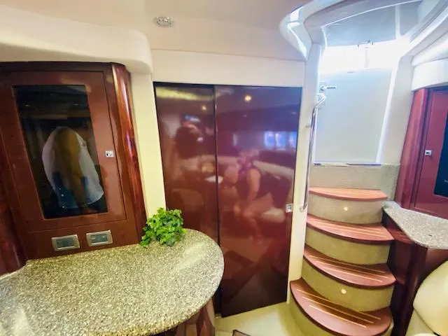 Slide: The Image of Interior of 2008 Sea Ray 440 Sundancer yacht with elegant wood finishes and curved staircase. - 39