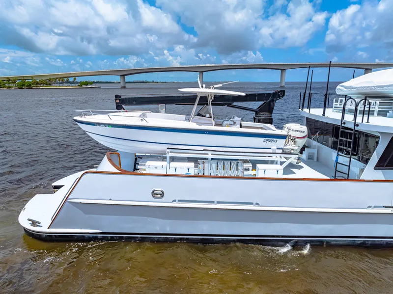 Slide: The Image of 1991 Expedition Freeport Yachts on water, bridge in background, clear sky. - 14